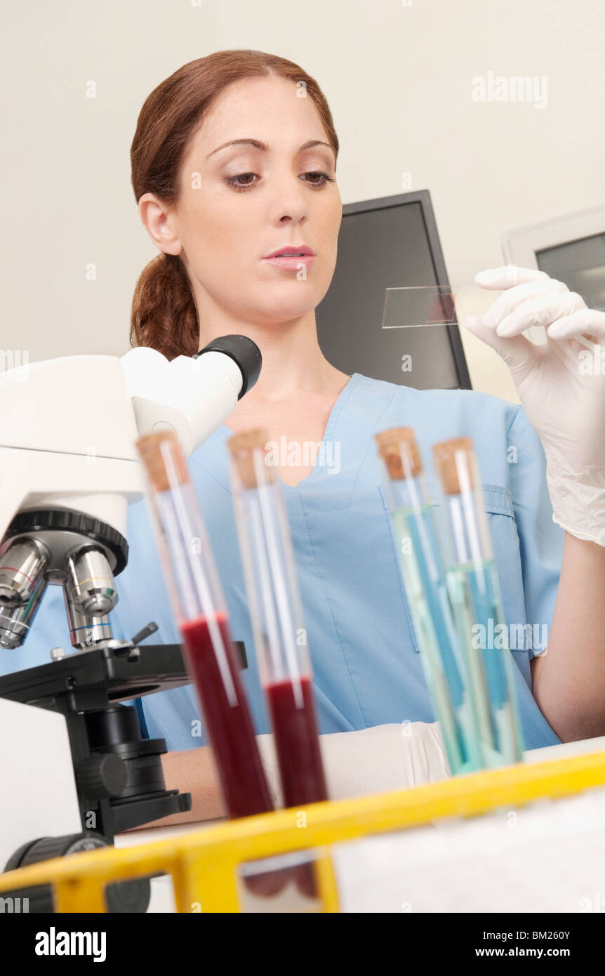 Female lab technician analyzing a sample in a laboratory Stock Photo