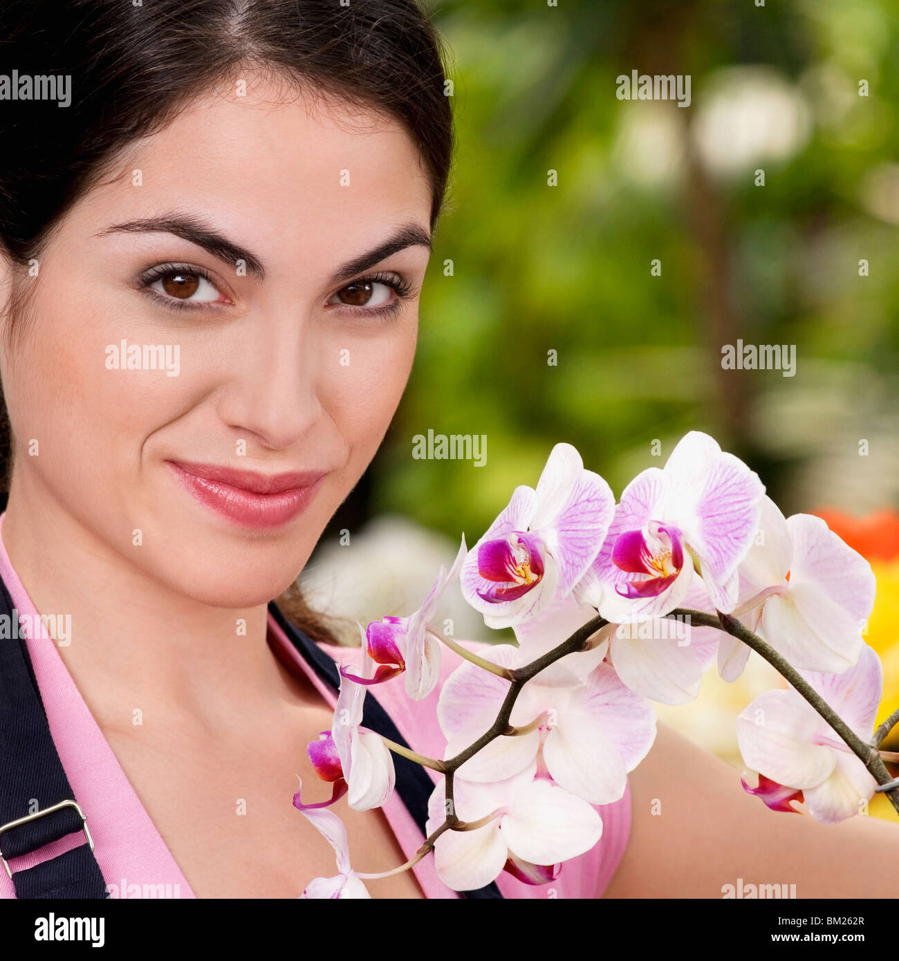 Portrait of a woman smiling in a greenhouse Stock Photo