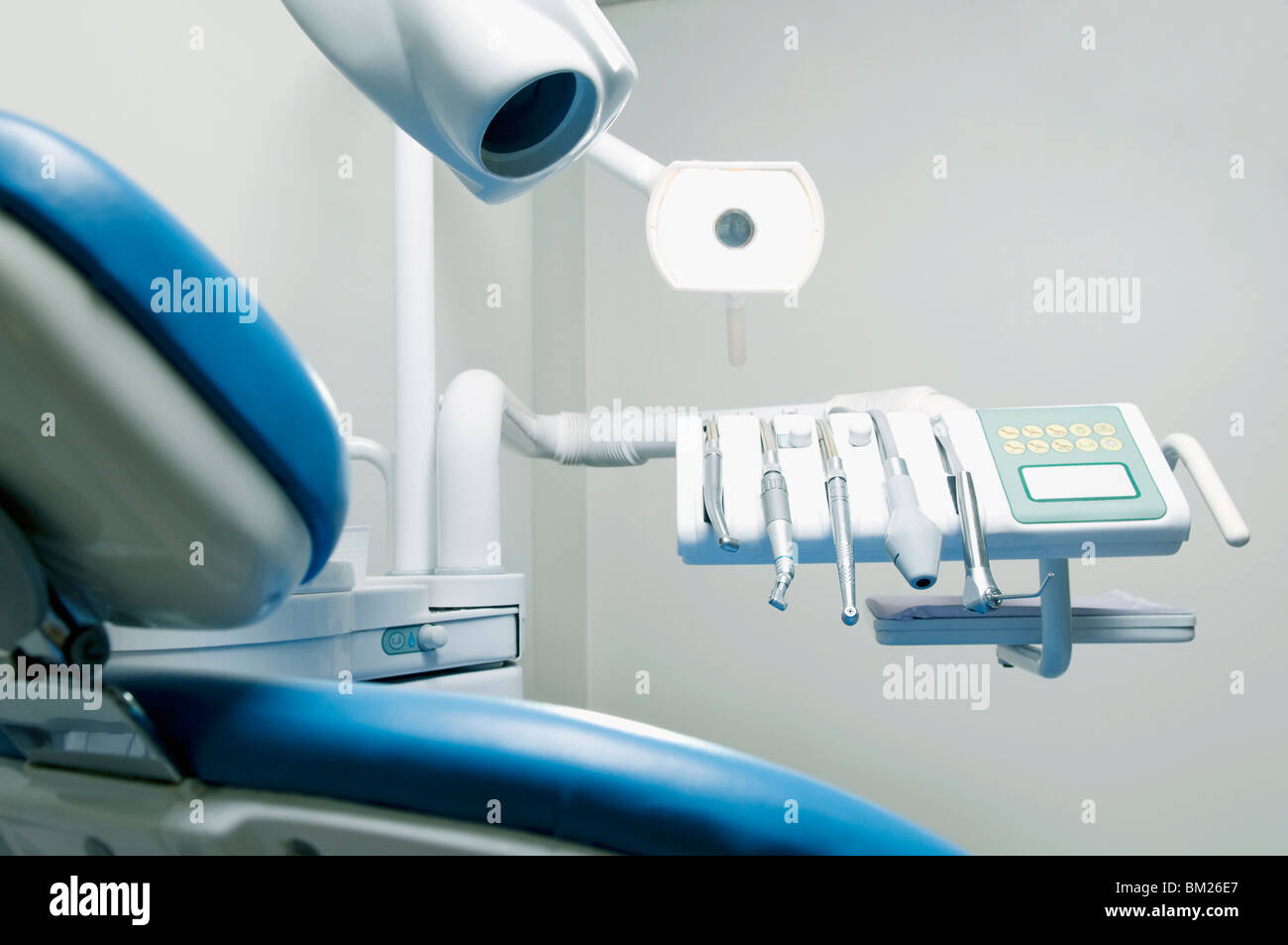 Dentist's chair with dental equipments in an examination room Stock