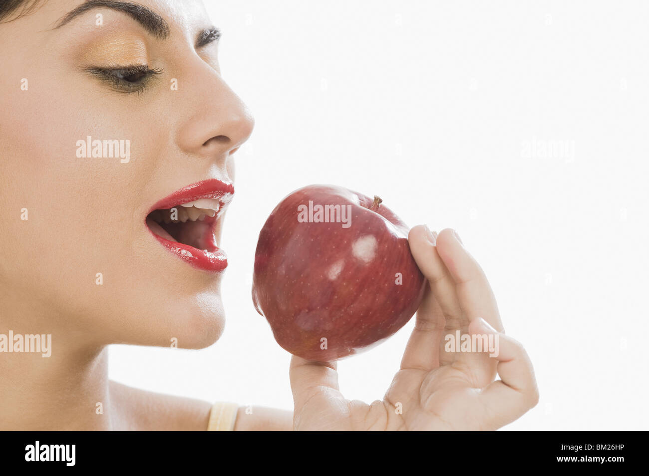 Close-up of a woman eating a red apple Stock Photo