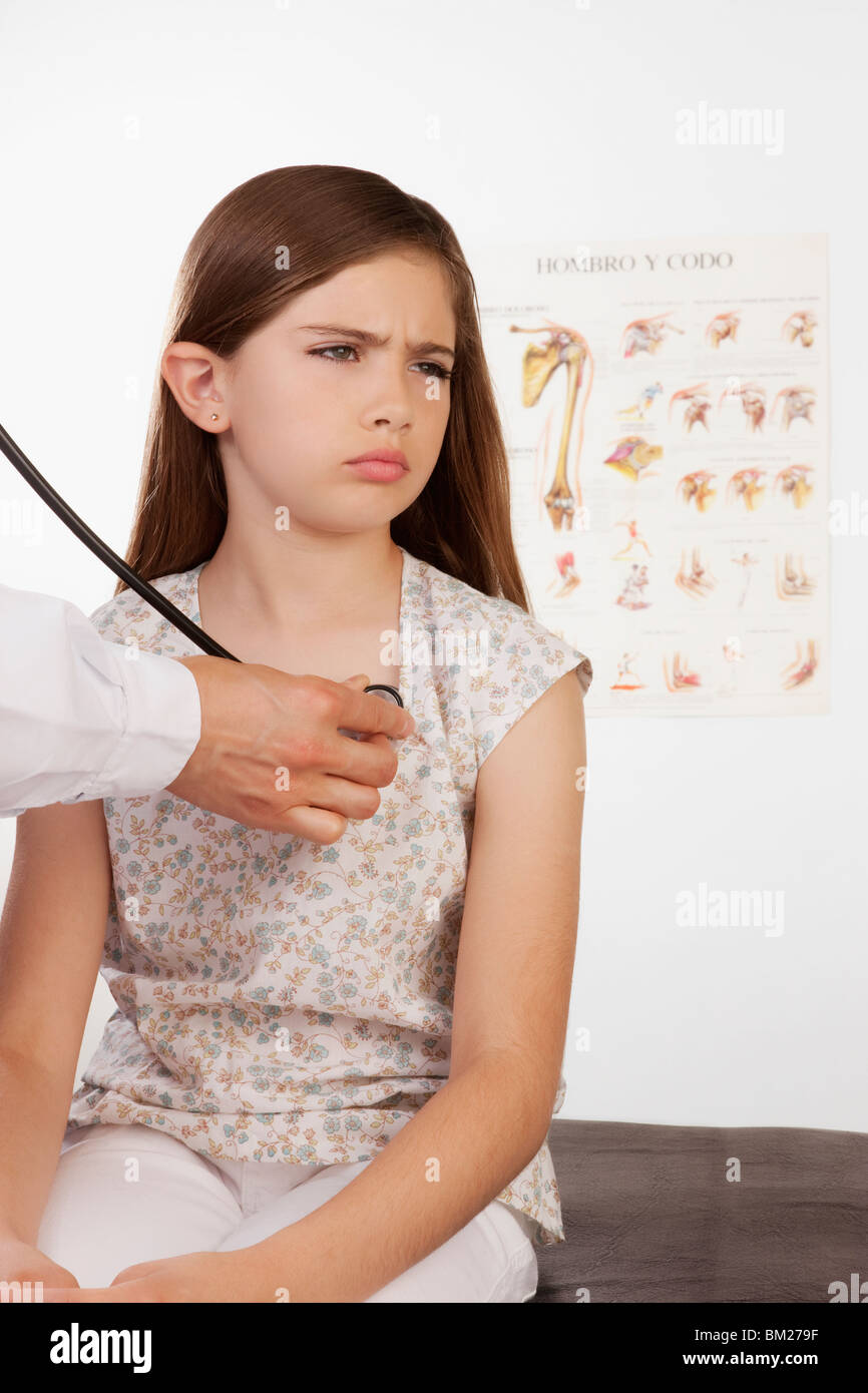 Doctor examining a girl with a stethoscope Stock Photo Alamy