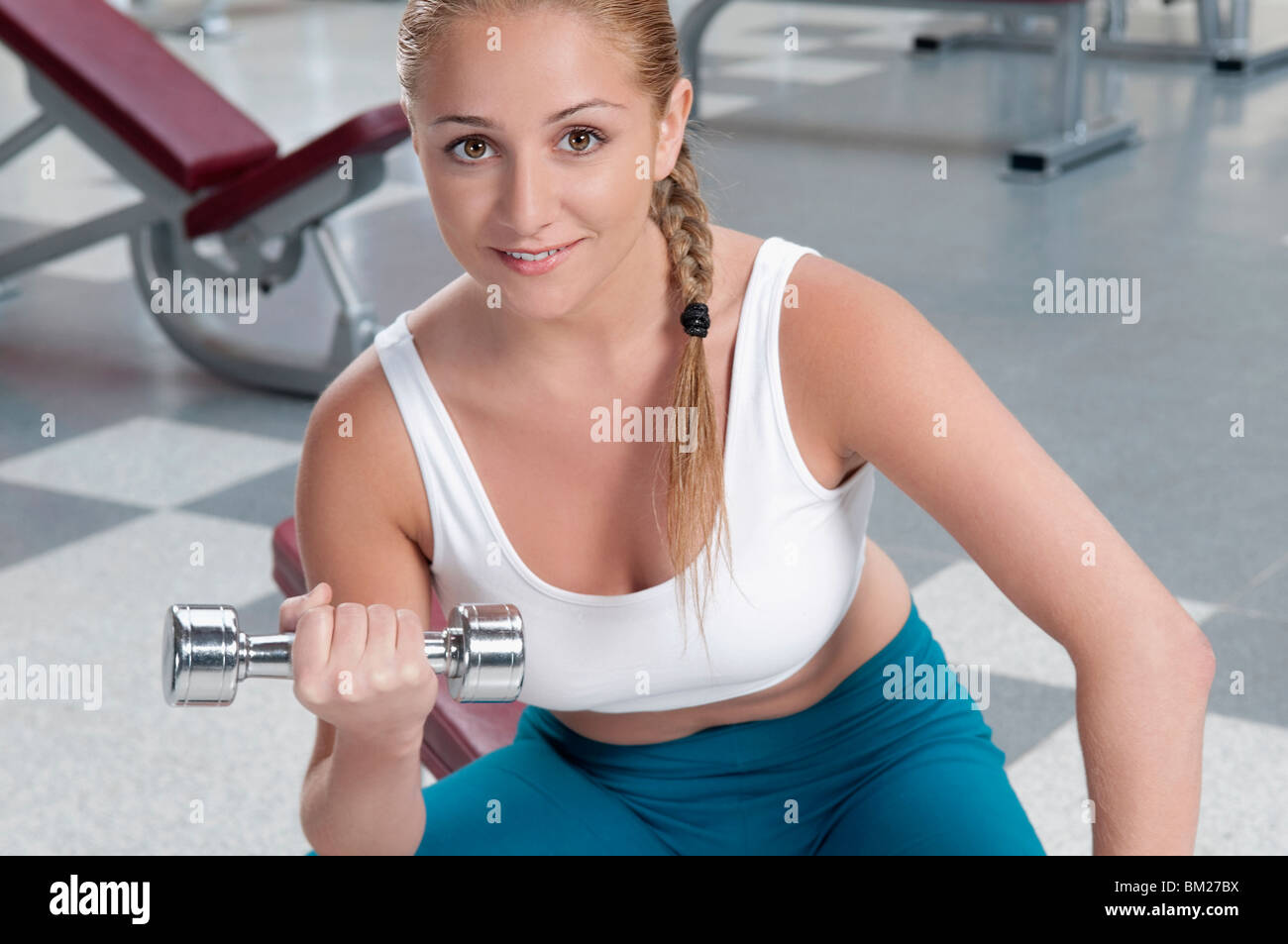Portrait of a woman exercising with a dumbbell Stock Photo