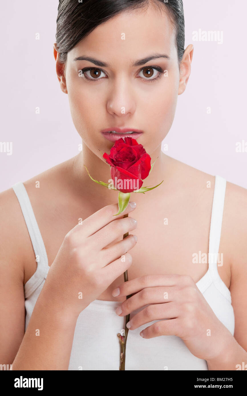 Portrait of a woman smelling a rose Stock Photo - Alamy
