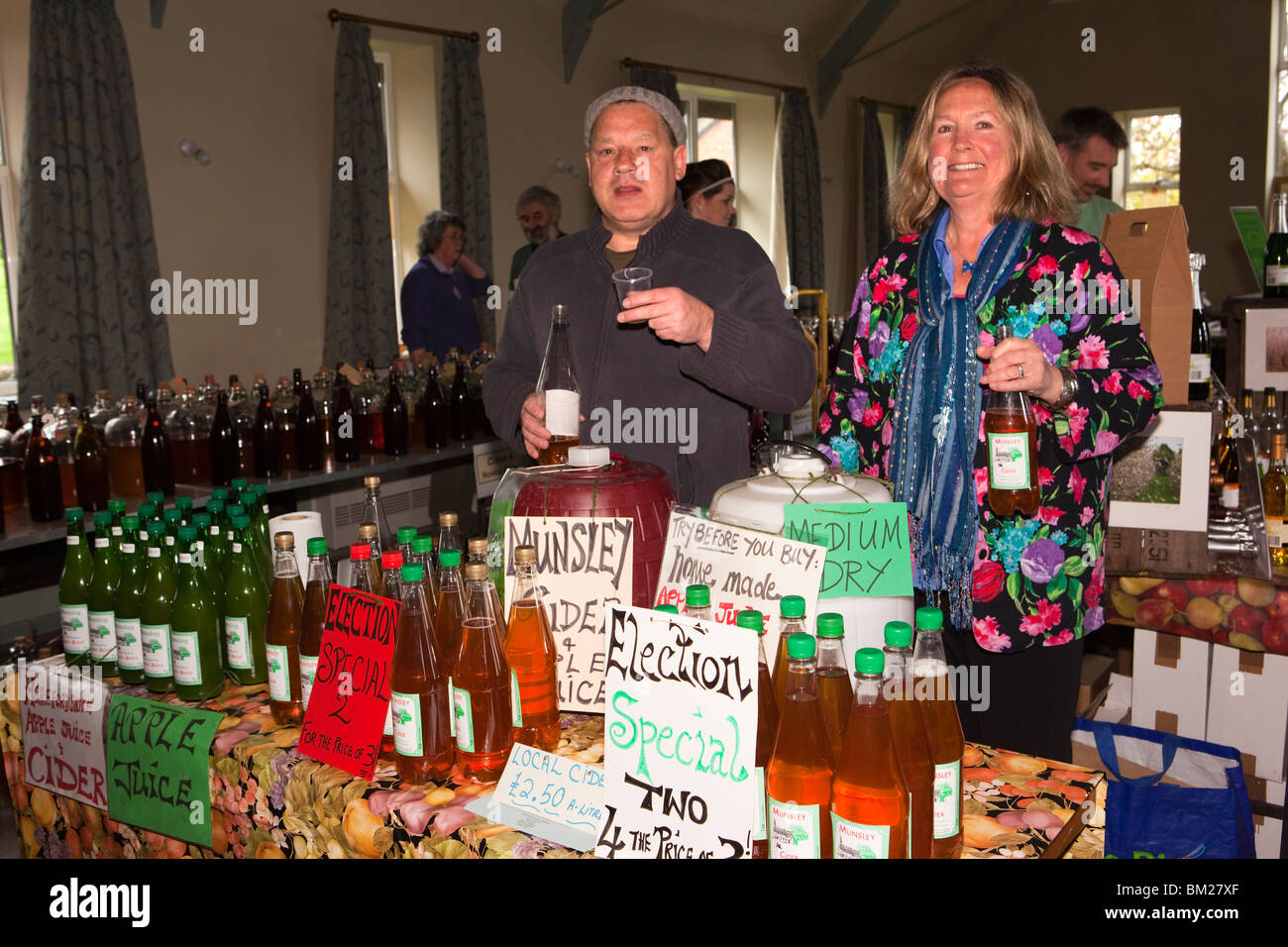 UK, England, Herefordshire, Putley, Big Apple Event, John and Georgina Stewart of Munsley Cider with their products Stock Photo