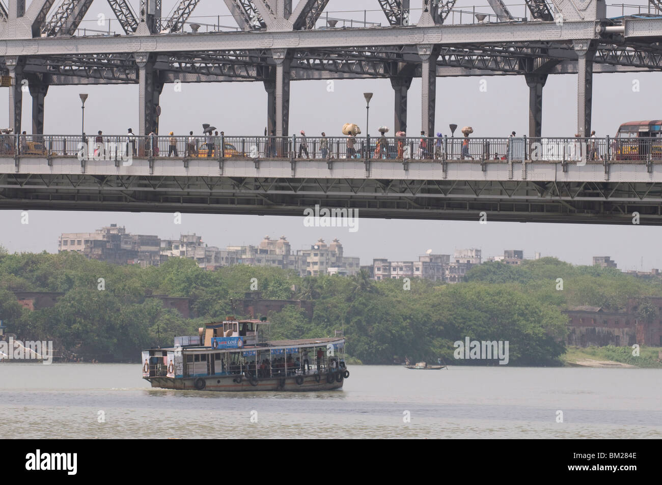 Passenger ferry under Howrah Bridge, Kolkata, West Bengal, India, Asia Stock Photo