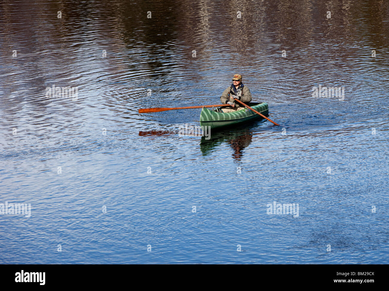 Fisherman rowing a small canoe , Finland Stock Photo Alamy