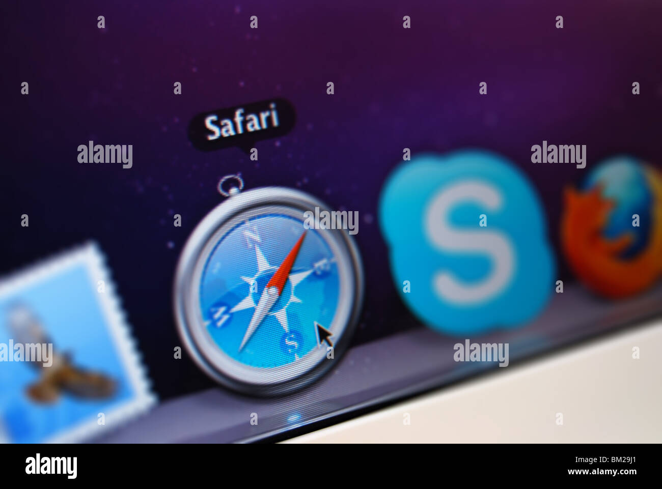 A Photo illustration of the Safari application in the dock of a macbook Stock Photo
