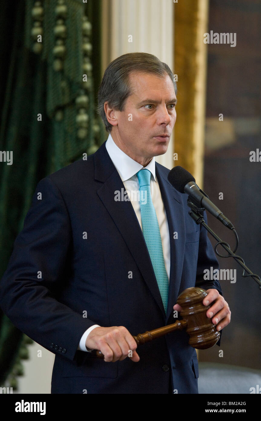 Texas Lieutenant Governor David Dewhurst holds a ceremonial gavel and speaks into a microphone on the dias of the Senate chamber at the Texas Capitol. Stock Photo