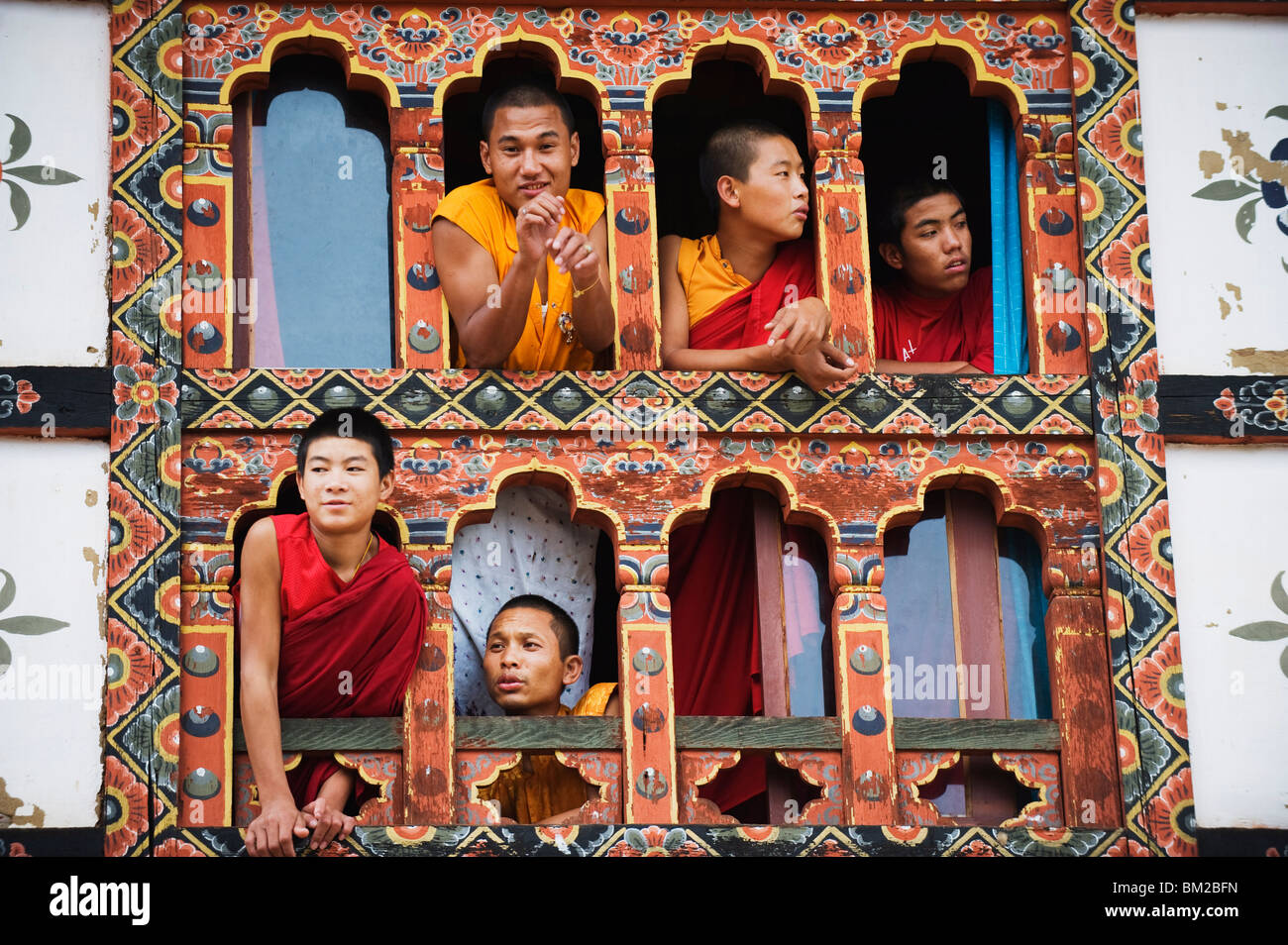 Young monks at a window, Chimi Lhakhang dating from 1499, Temple of the Divine Madman Lama Drukpa Kunley, Punakha, Bhutan Stock Photo