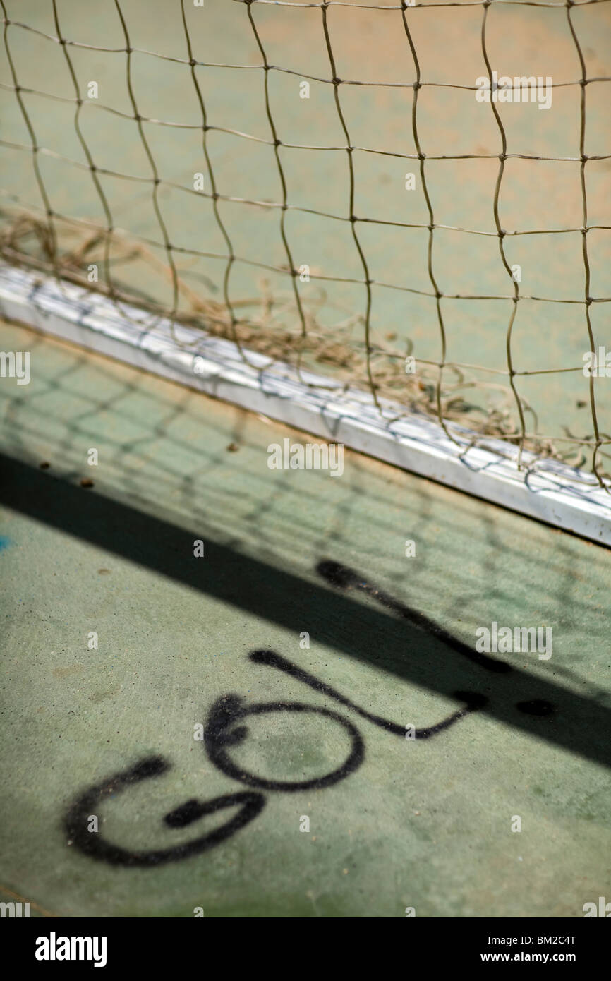 The Spanish word "gol!" (goal!) painted on the ground by a football
