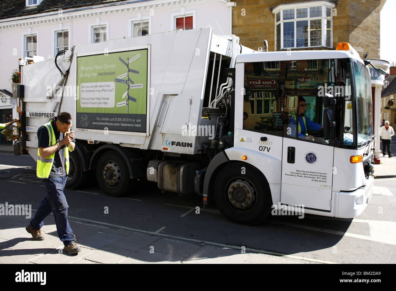 Dustbin men at work on Rubbish collection day in an English town Stock