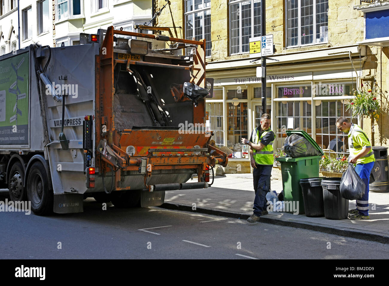 Dustbin men at work on Rubbish collection day in an English town Stock
