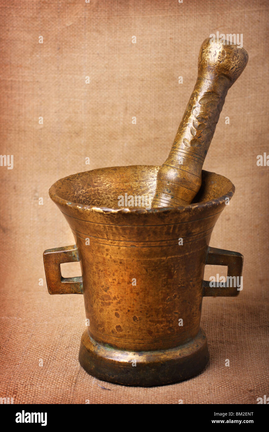 Old bronze mortar and pestle on sacking background Stock Photo Alamy