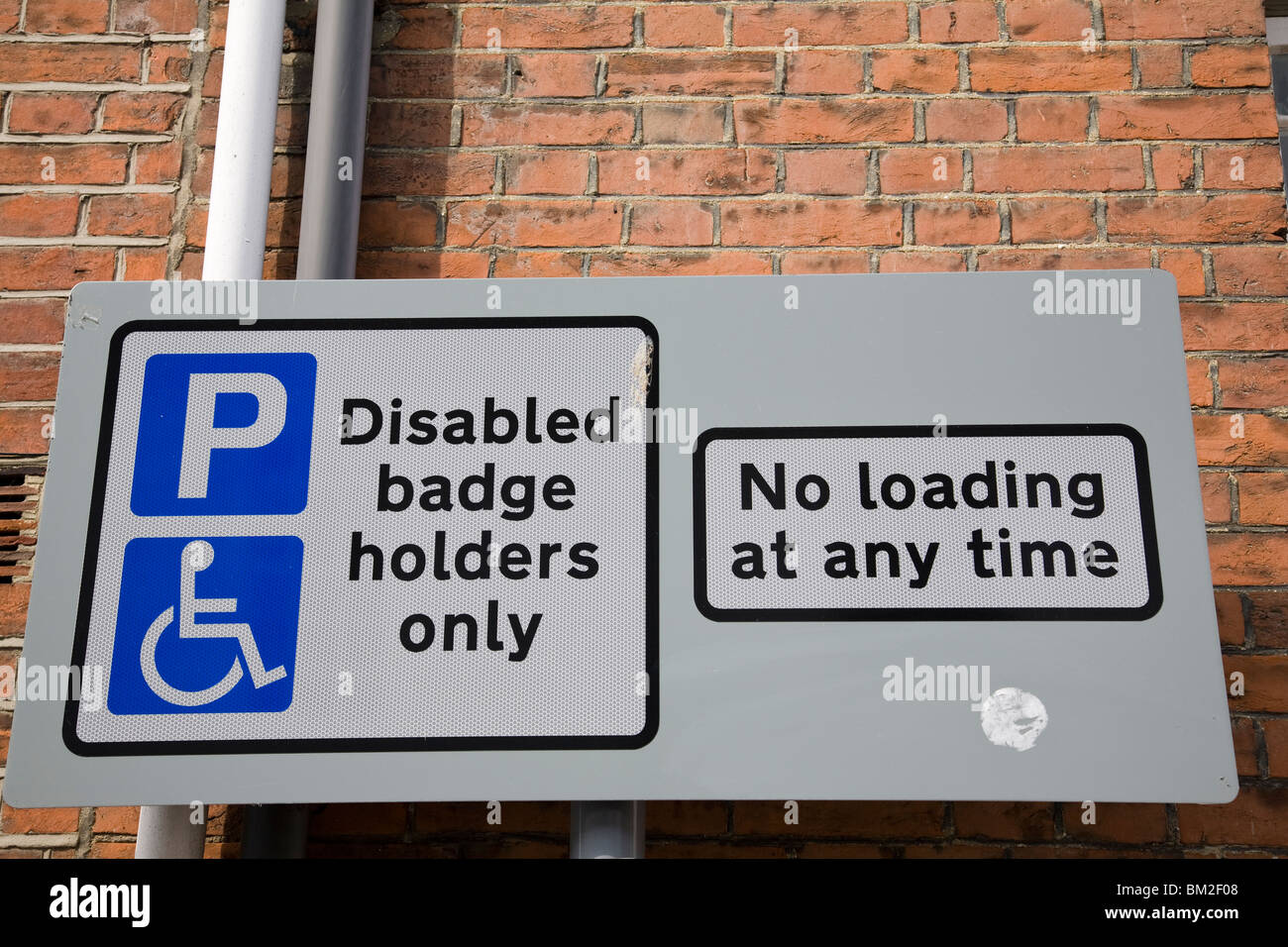 a-disabled-badge-holders-only-and-a-no-loading-sign-england-stock