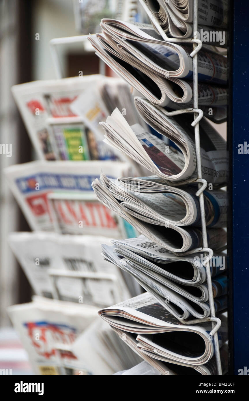 A collection of international newspapers on sale in Fleet Street, London, UK Stock Photo