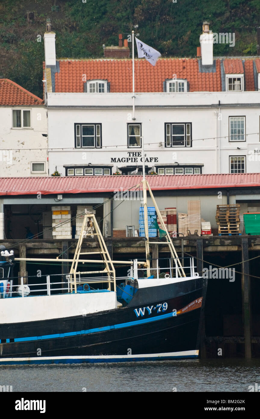 Fishing boats in Whitby harbour with the famous Magpie Cafe in the background, Whitby, Yorkshire, UK Stock Photo