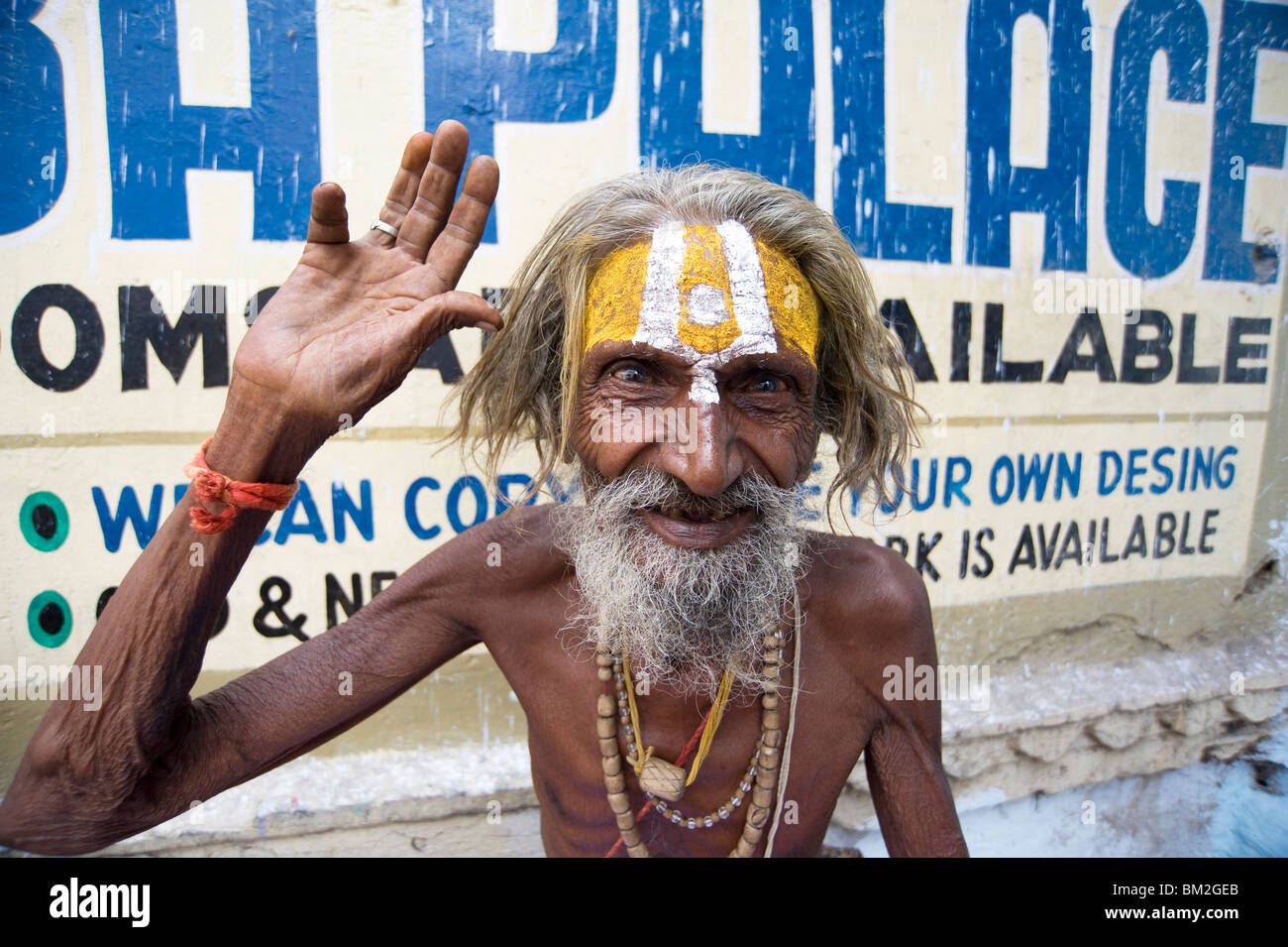 Holy man (Saddhu) with red cotton rolimoli on wrist and tilak mark on forehead, Udaipur, Rajasthan, India Stock Photo