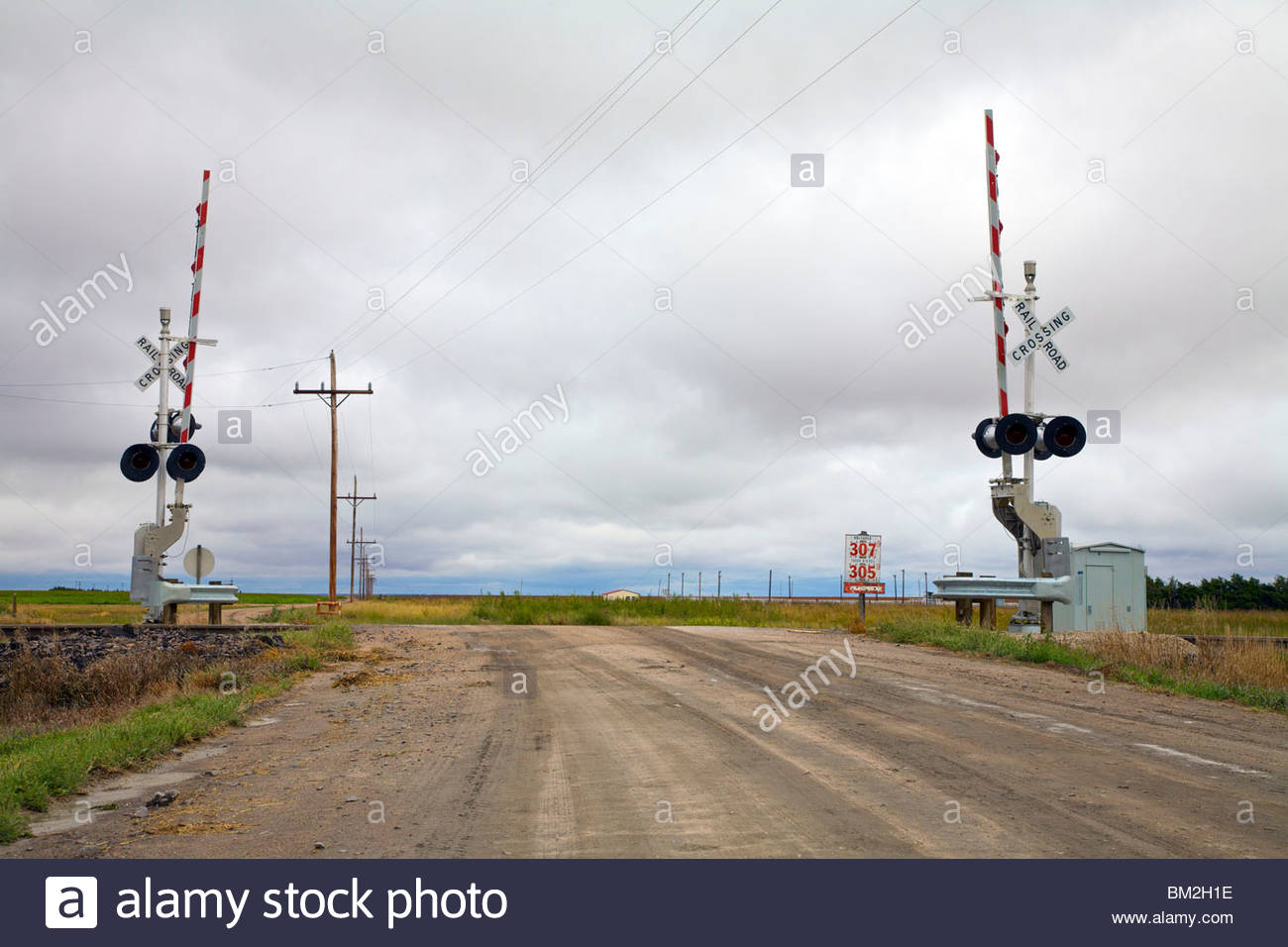 A rural dirt road and railroad crossing in Kansas, United States Stock
