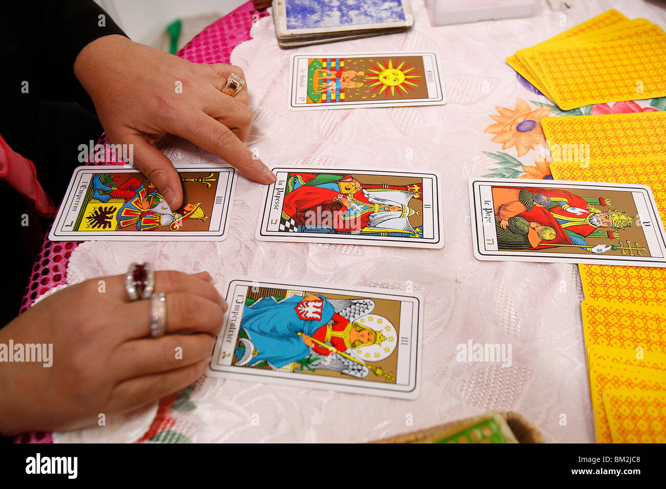 Fortuneteller laying cards on the table during a divination, Paris, France Stock Photo