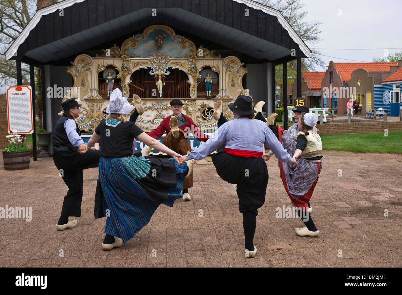 Traditional Dutch dancers performing in front of Amsterdam street organs in Netherlands Village Holland Michigan USA Stock Photo