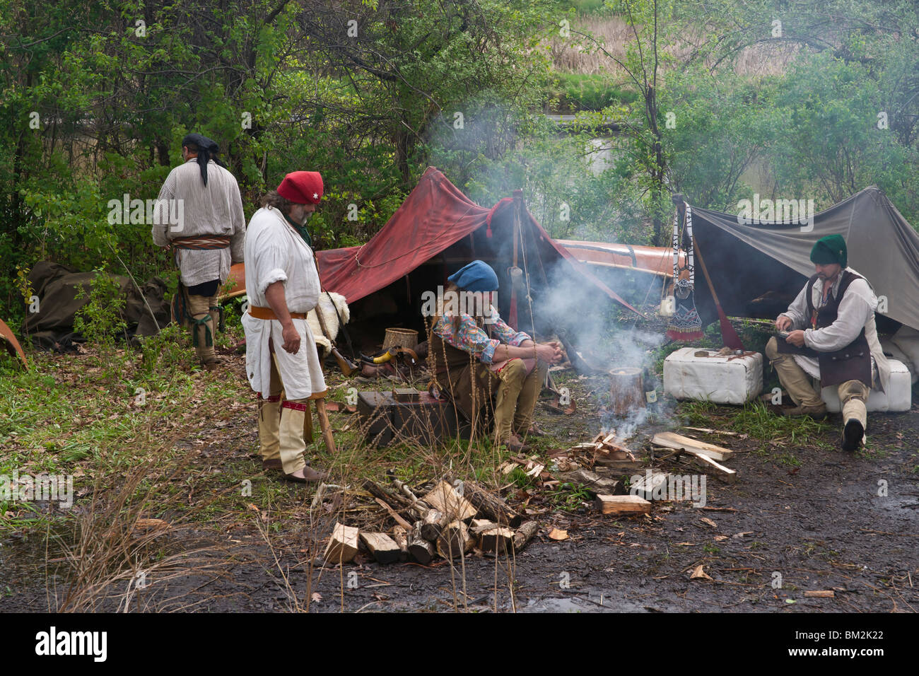 Tulip time festival Dutch Holland Michigan USA US settlers setler traditional costume sitting by a bonfire in a camp native trade fair unusual hi-res Stock Photo