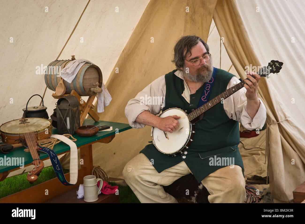 A male musician dressed in XVIII century Dutch costume playing banjo during Tulip Time Festival in Holland Michigan Stock Photo