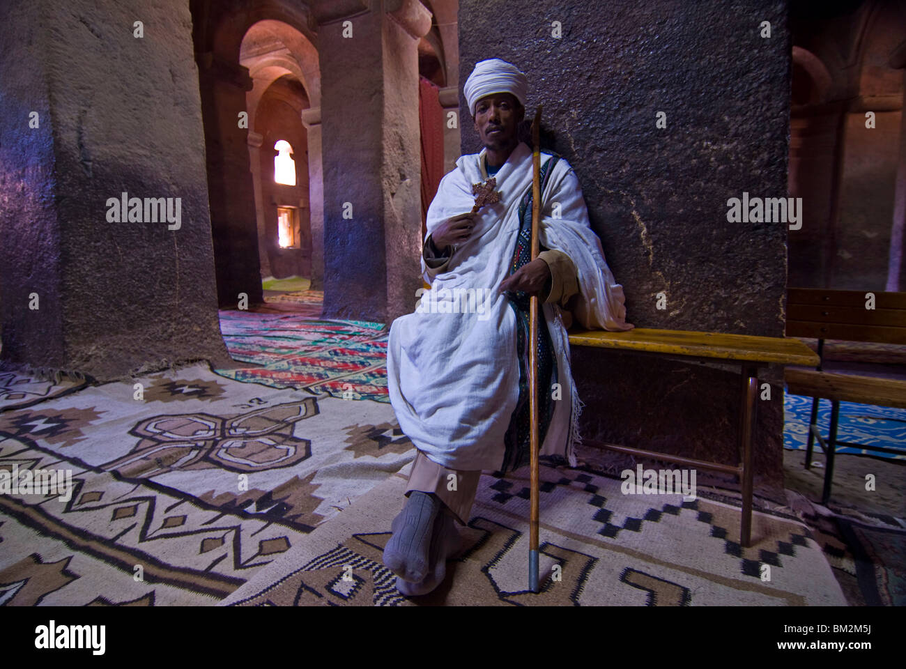 Monk sitting in the rock carved monastery of Lalibela, Northern Ethiopia Stock Photo