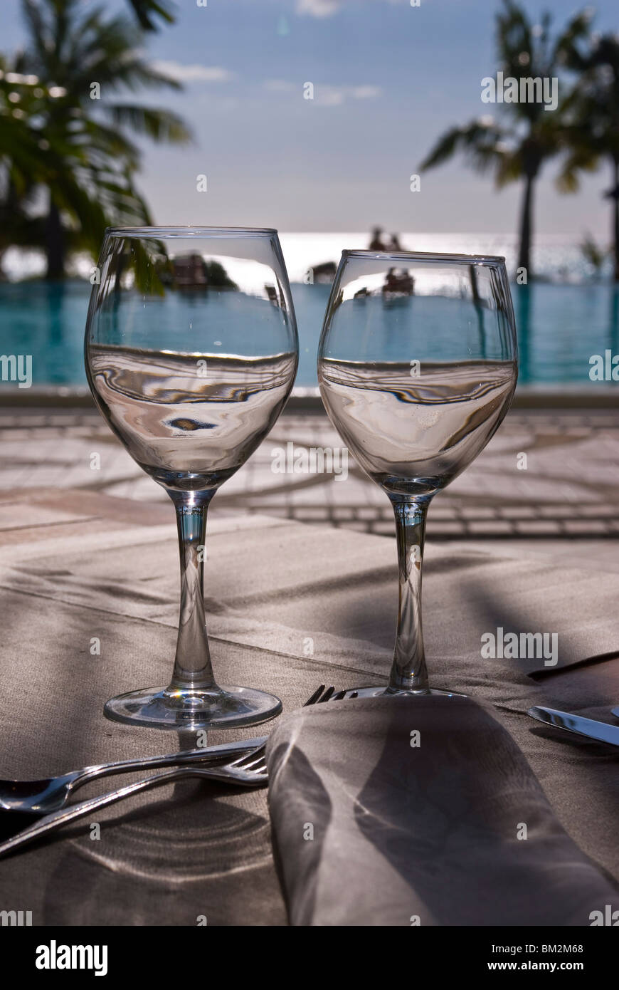 Wine glasses in front of the pool of the Beachcomber Le Paradis, Mauritius, Indian Ocean Stock Photo