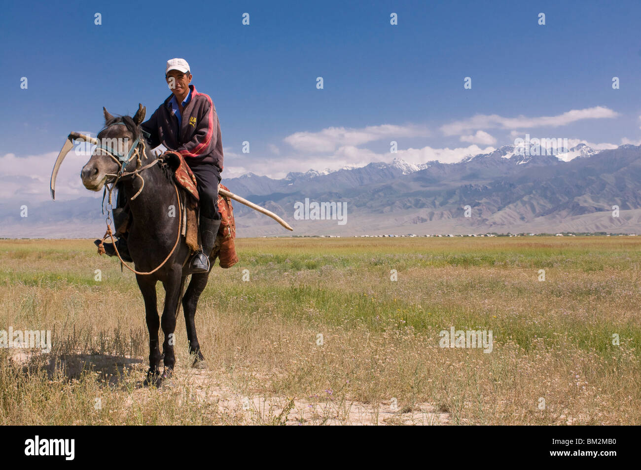 Kyrgyz man on his way to harvest, Torugat Pass, Kyrgyzstan Stock Photo