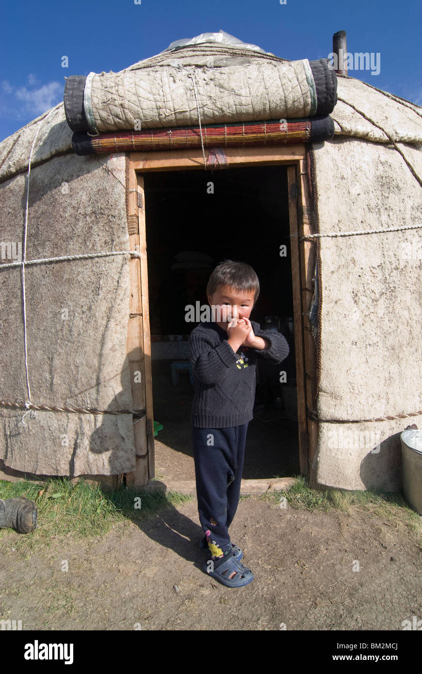 Child in yurt, tent of Nomads at Song Kol, Kyrgyzstan Stock Photo