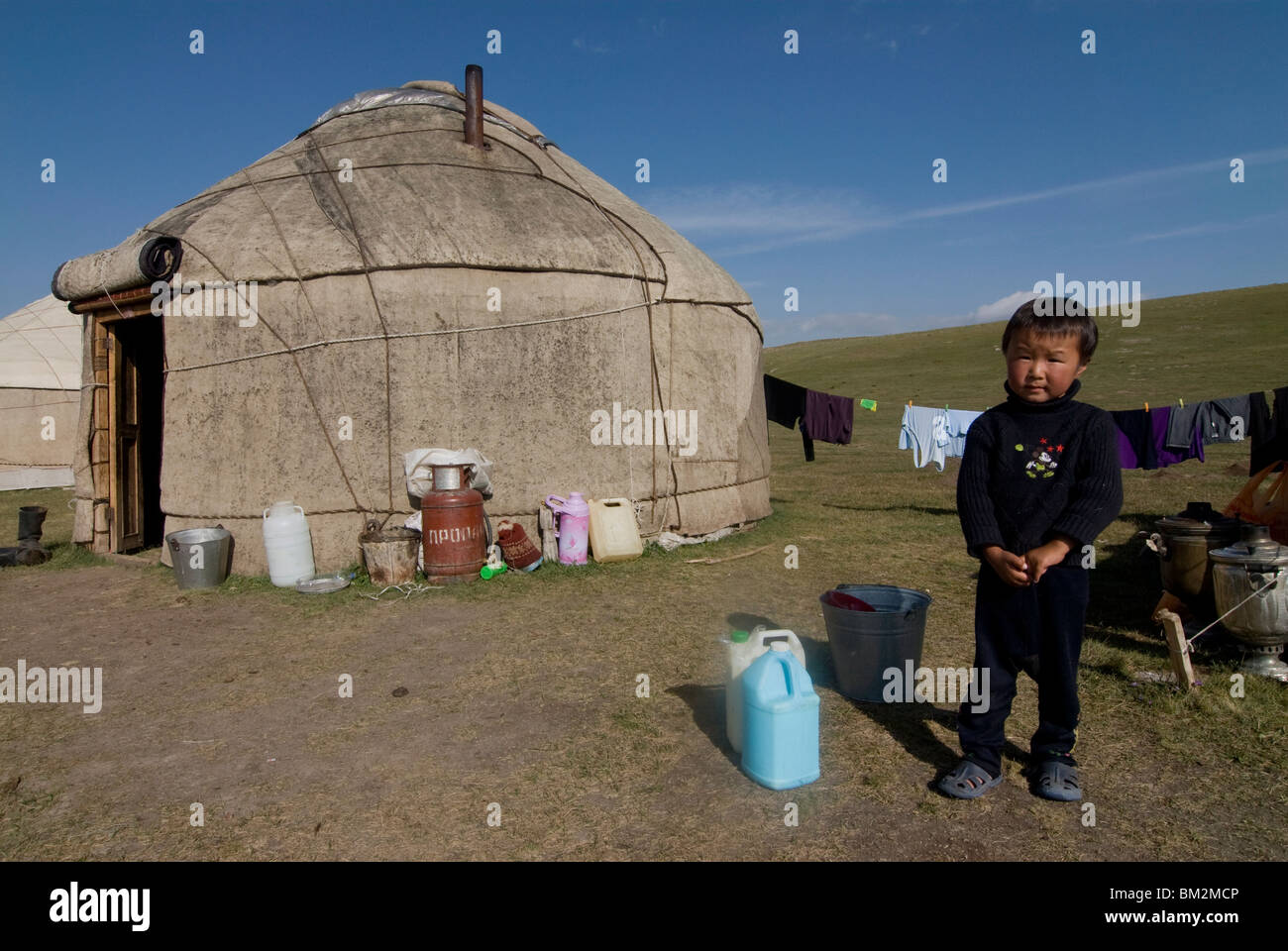 Kyrgyz boy in front of a yurt at Song Kol, Kyrgyzstan Stock Photo