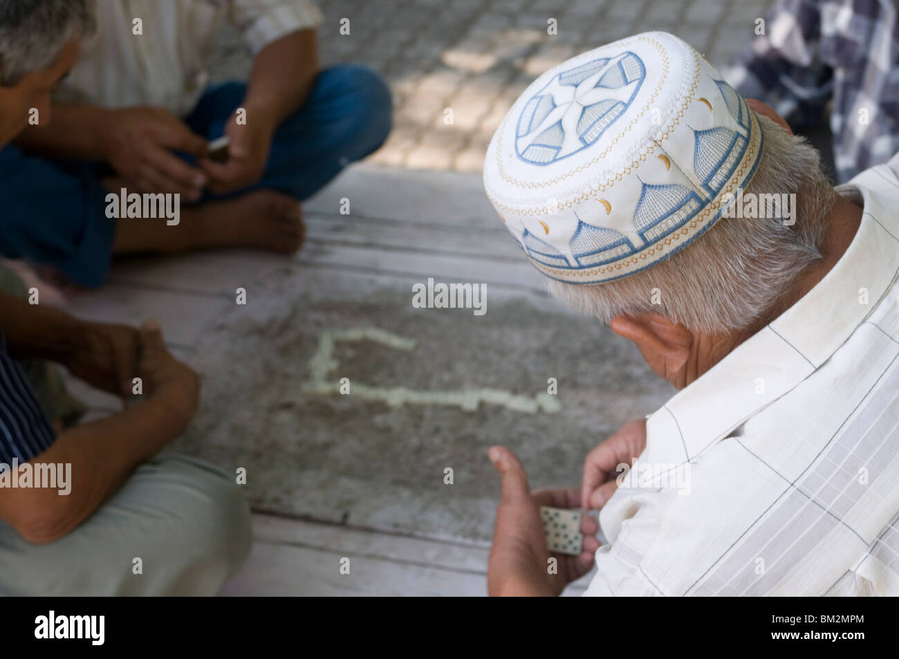Men playing dominos, Bokhara, Uzbekistan Stock Photo
