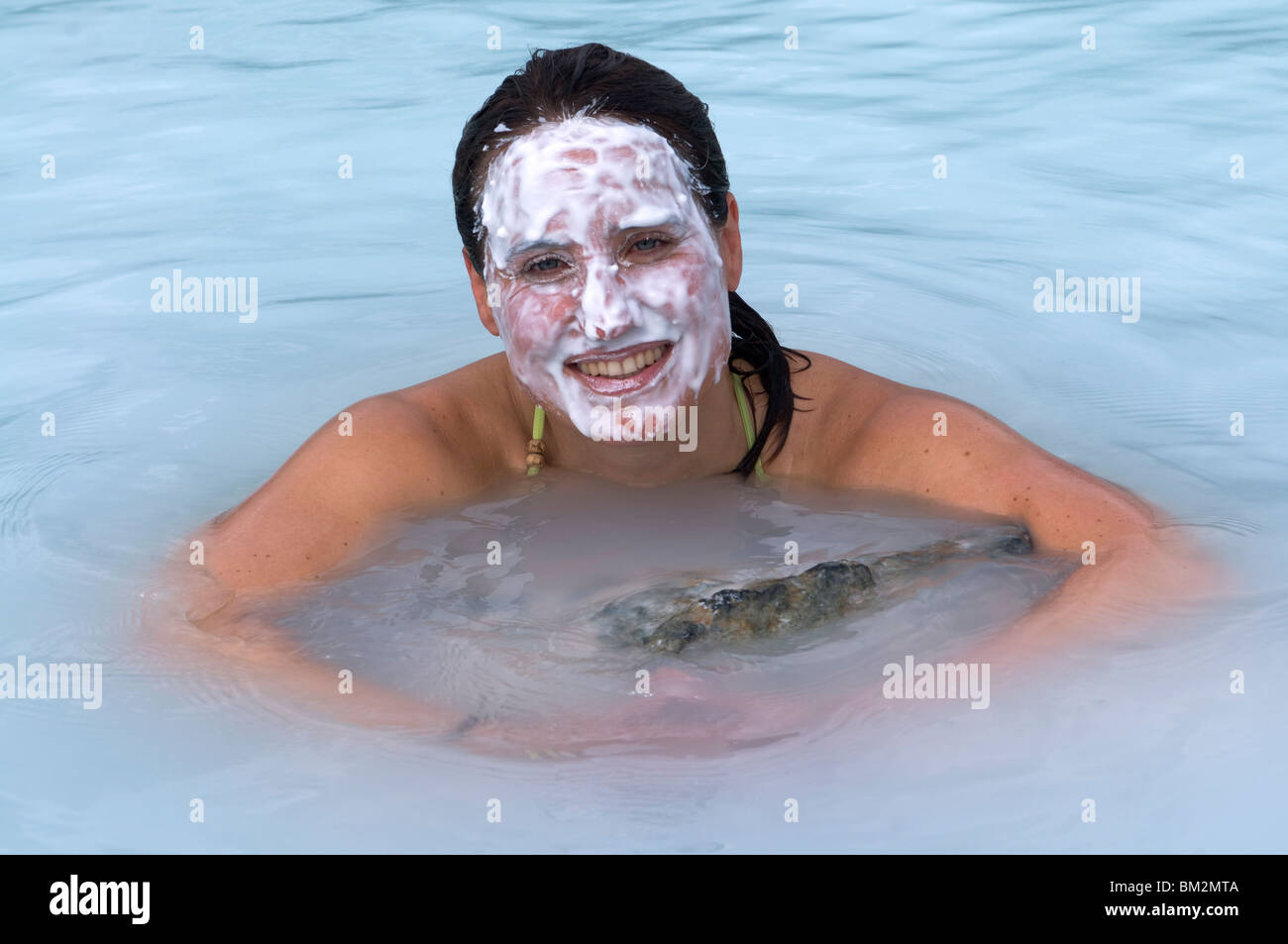Young woman enjoying bathing in hot spring, Blue Lagoon, Iceland, Polar Regions Stock Photo