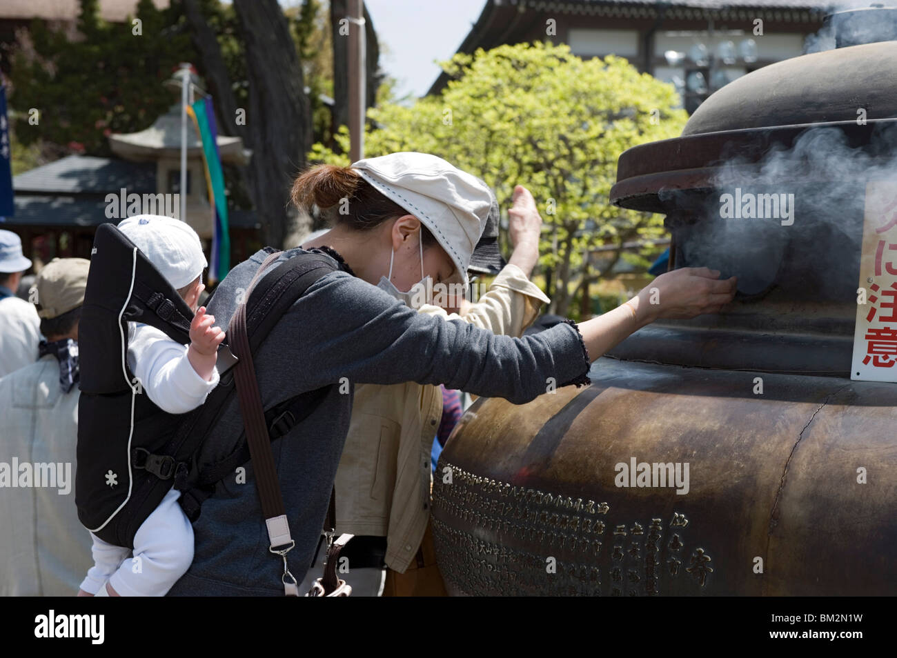 Mother baby using incense smoke hires stock photography and images Alamy