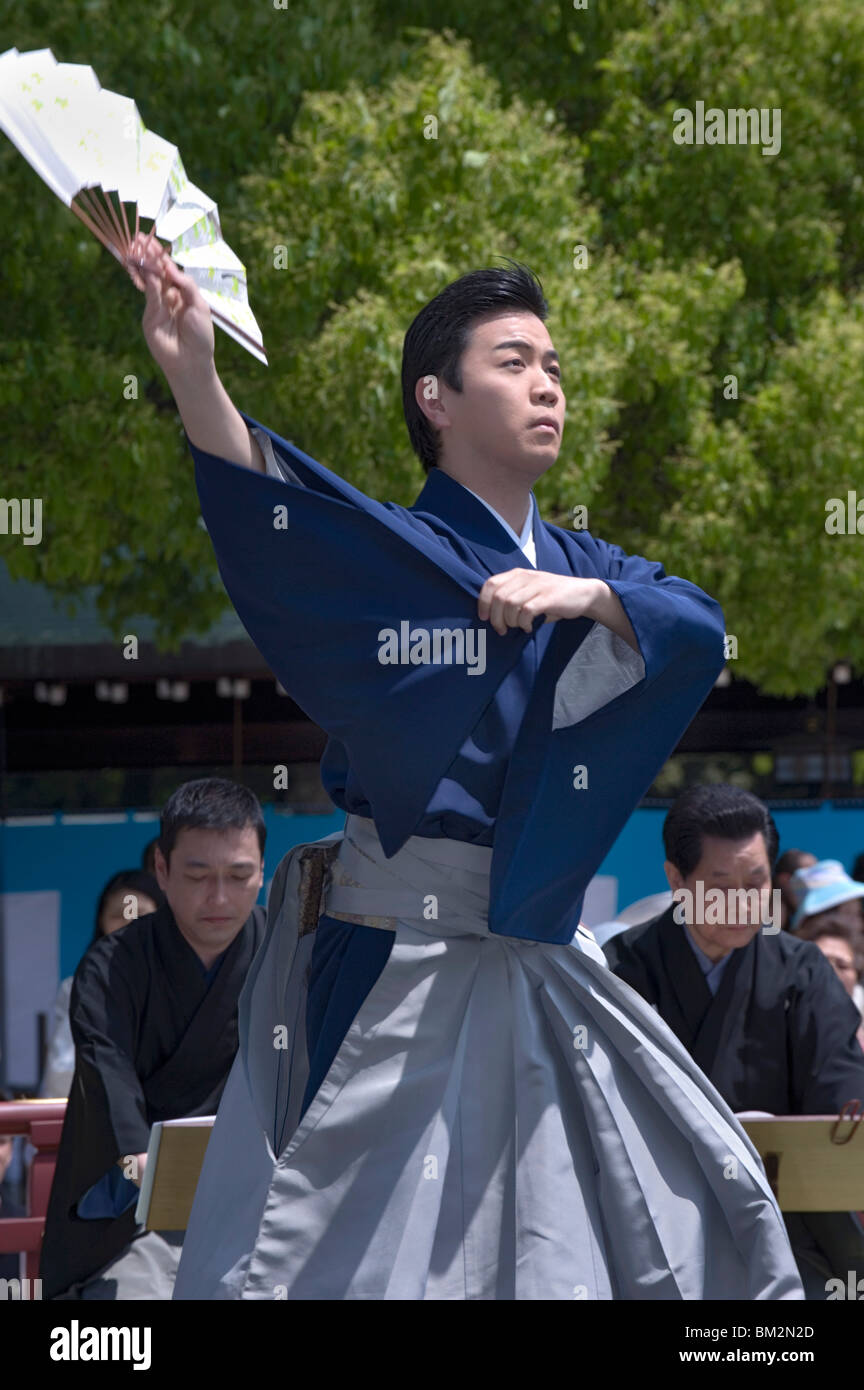 Man with fan performing classical Japanese dance called hobu at Meiji