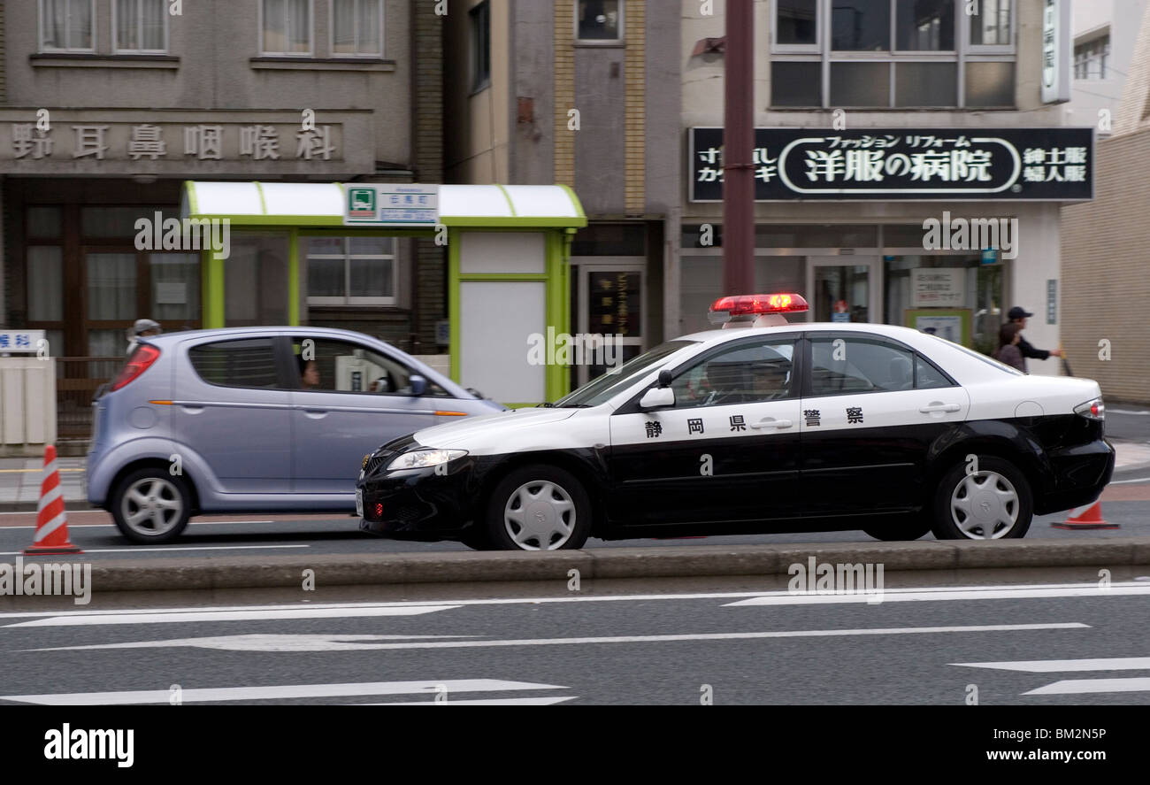 A police car from Shizuoka Prefecture speeding past, Tokyo, Japan Stock Photo