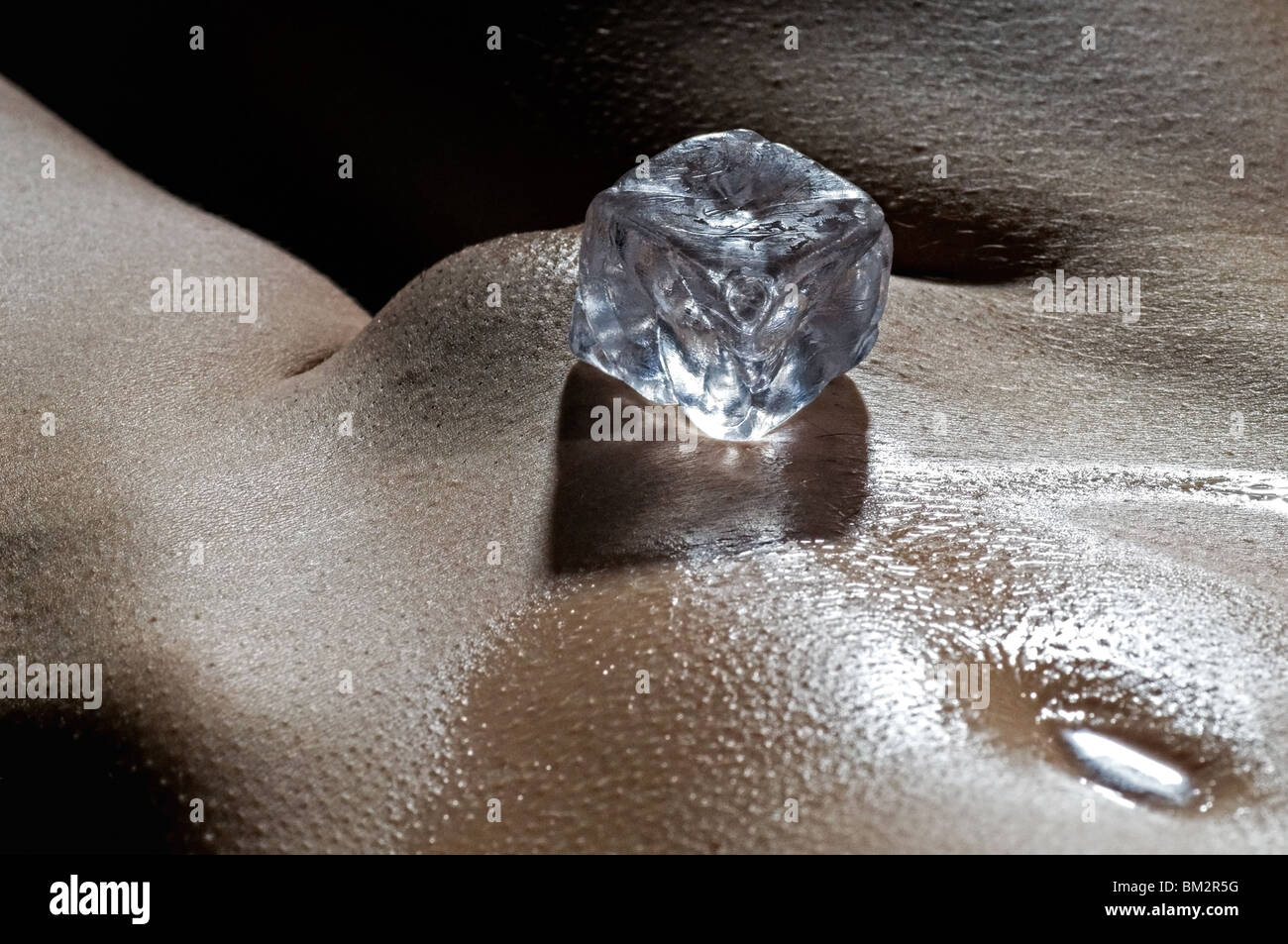 Ice cube on womans stomach Stock Photo Alamy