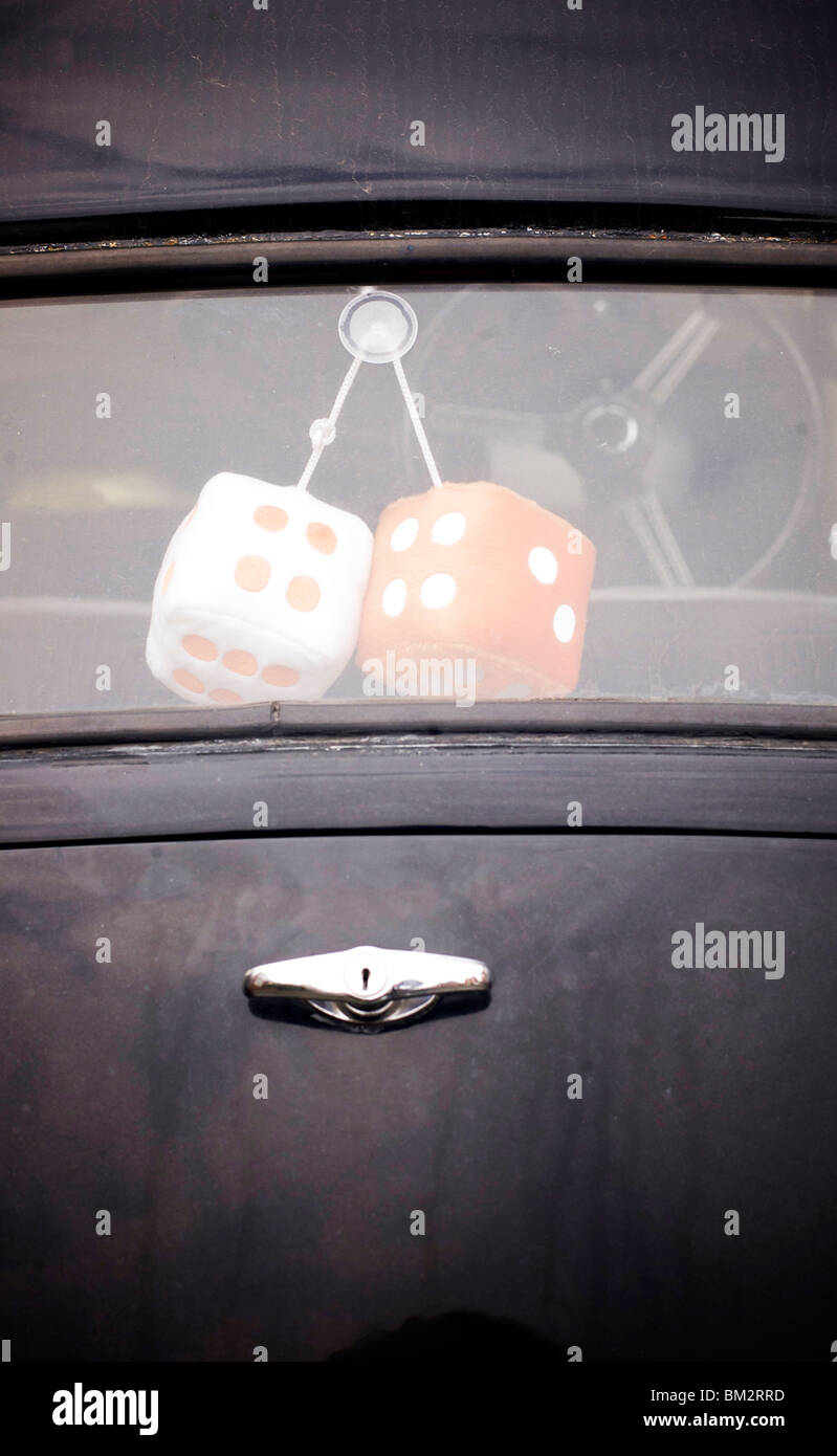 Furry dice in rear window of Austin Prefect car. Stock Photo