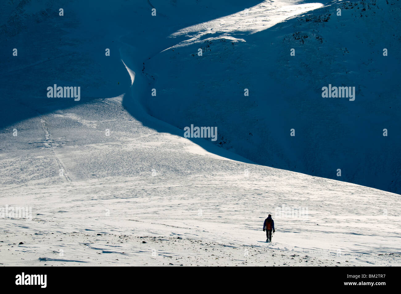 A walker on Coledale Hause in winter, Grasmoor Fells, Lake District, Cumbria, England, UK Stock Photo