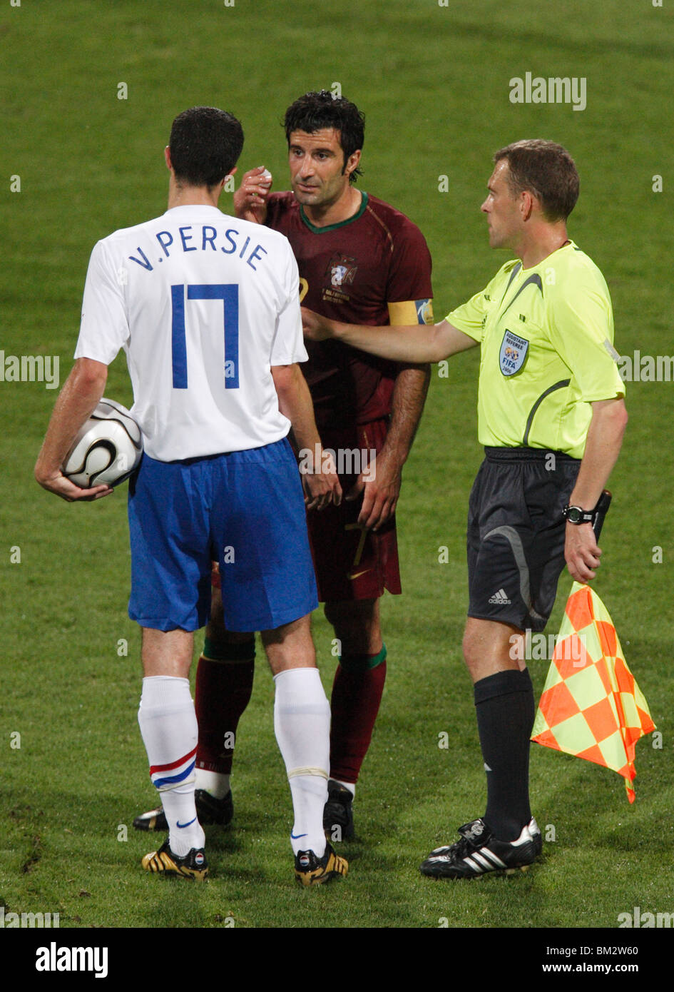 Robin Van Persie of Holland and Luis Figo of Portugal are separated by an assistant referee during a 2006 World Cup match. Stock Photo