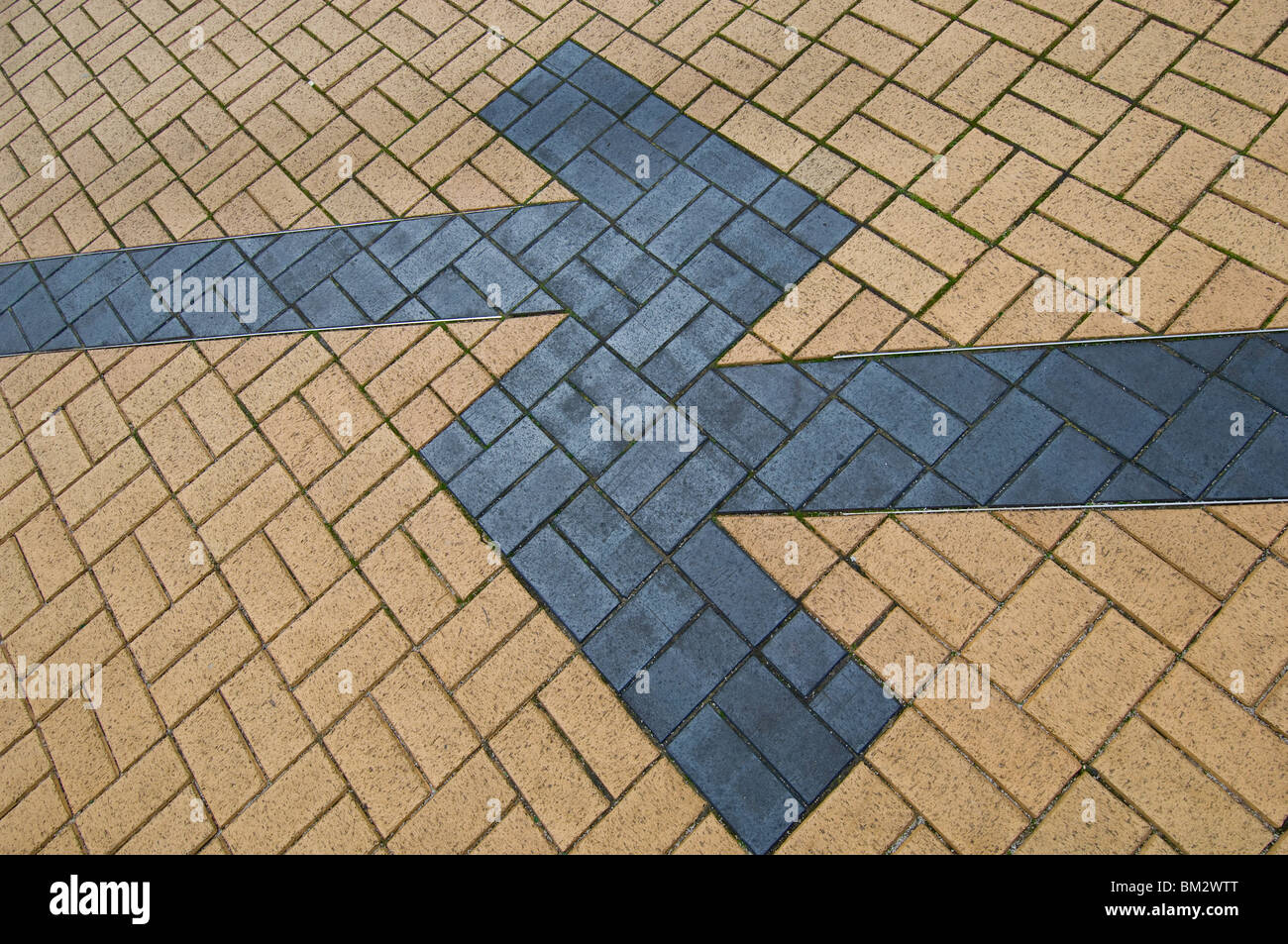Colored blocks formed in a station platform in the shape of arrows Stock Photo
