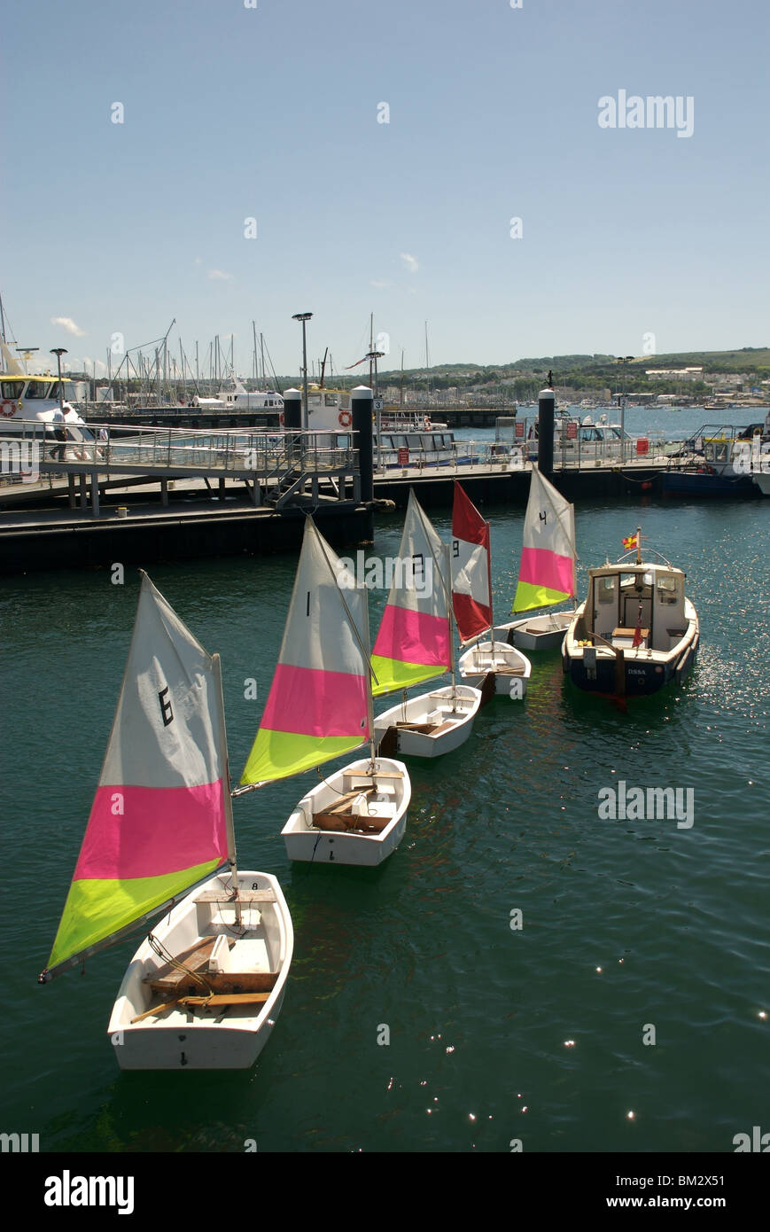 Colourful numbered sailing dinghies in a row, Barbican pontoon