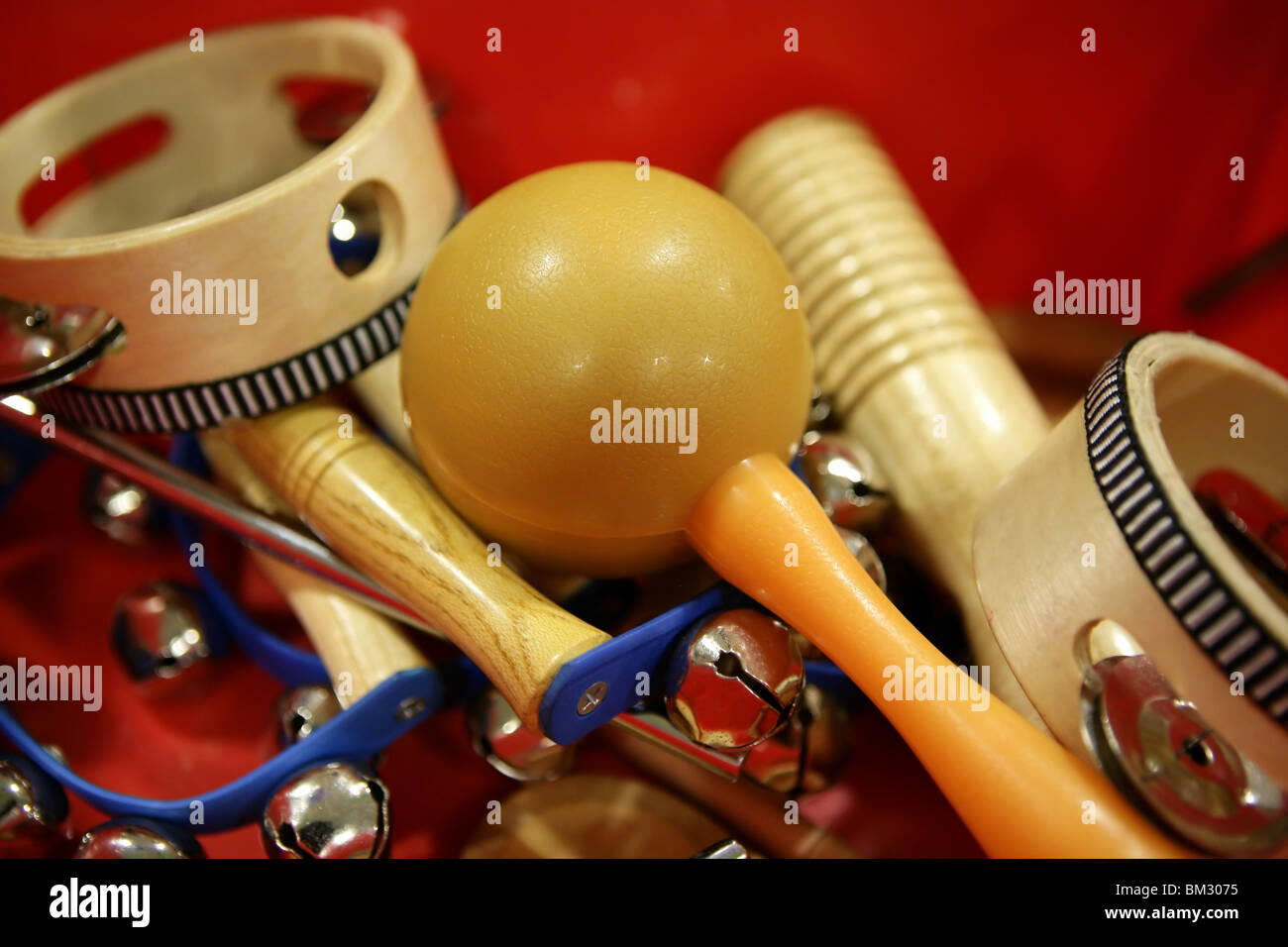 mixed percussion toy instruments over red background Stock Photo