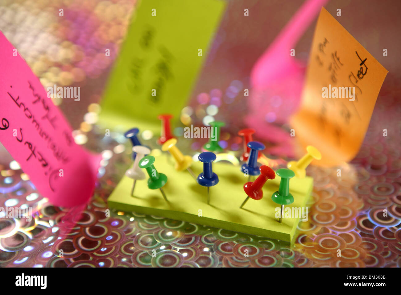 adhesive color notes with colorful pin over holographic background