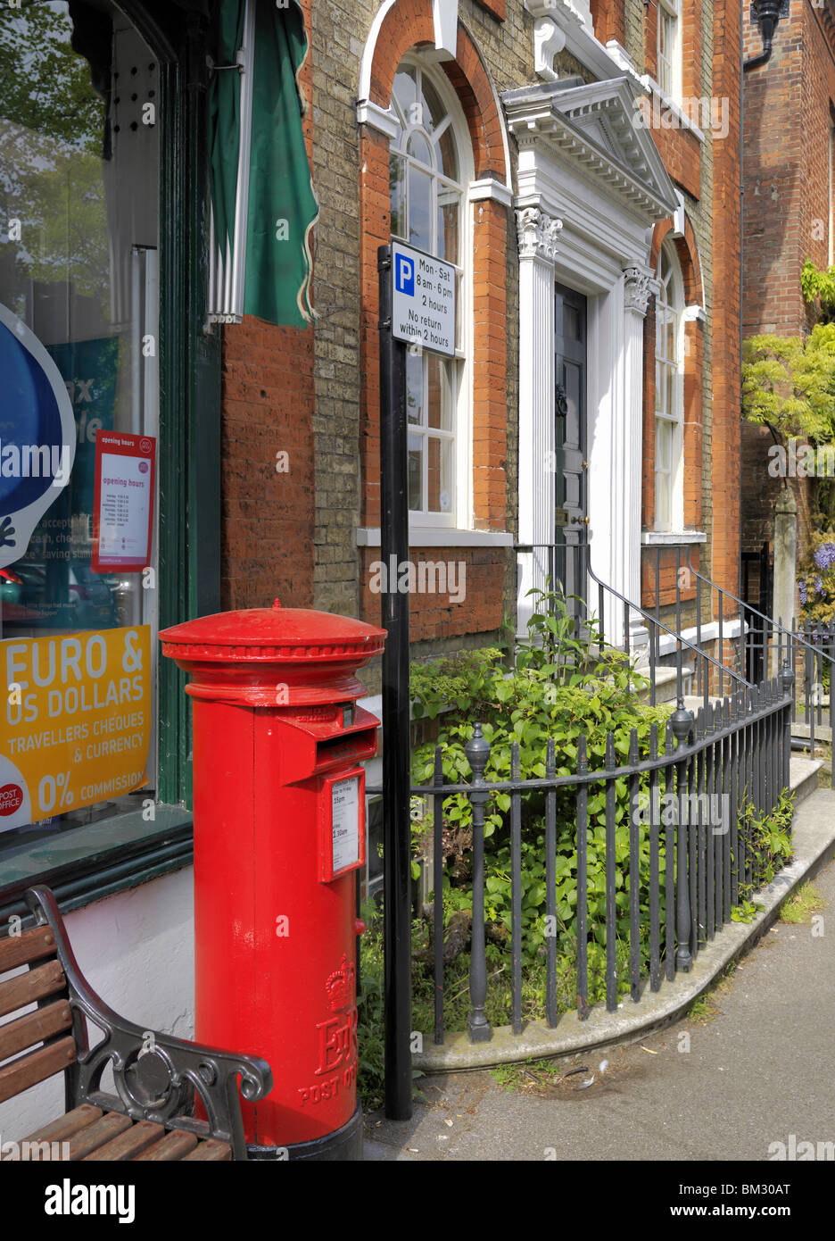 Red post box and house, Dedham Stock Photo
