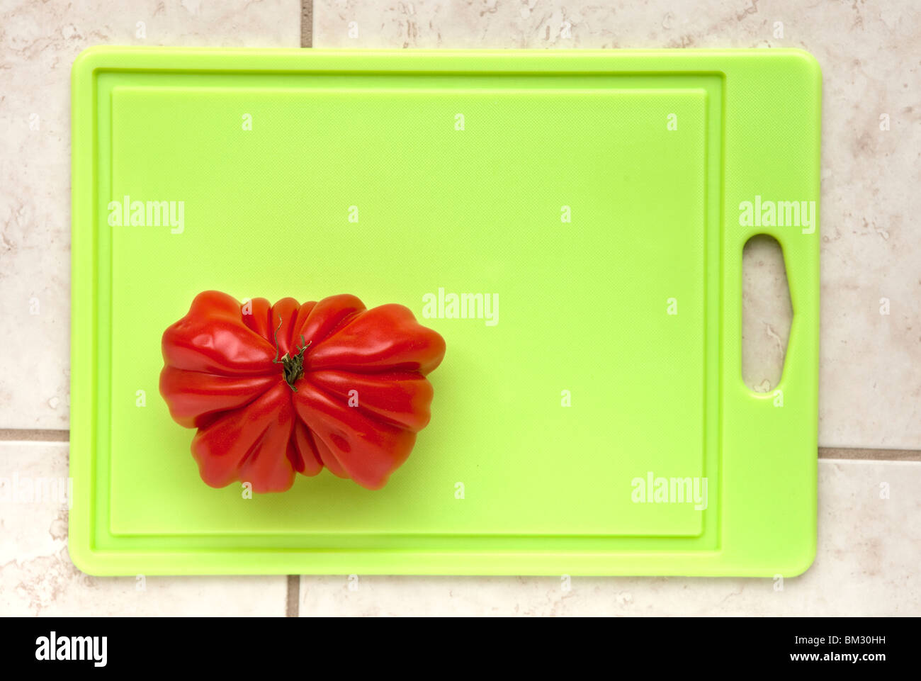 tomato on cutting board Stock Photo