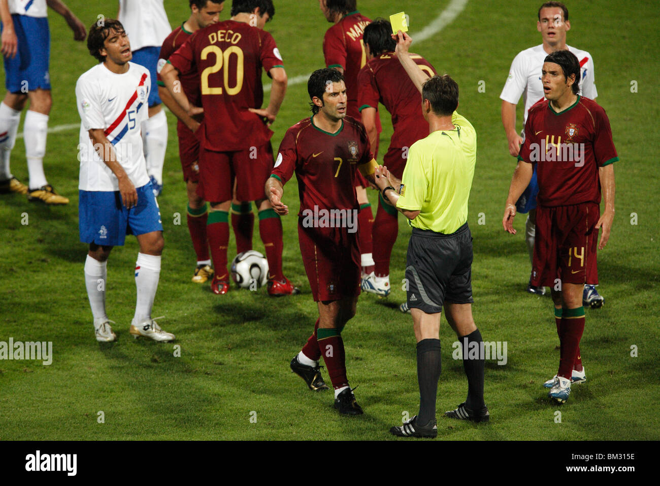 Referee Valentin Ivanov issues a yellow card caution to Luis Figo of Portugal (7) during 2006 World Cup match against Holland. Stock Photo