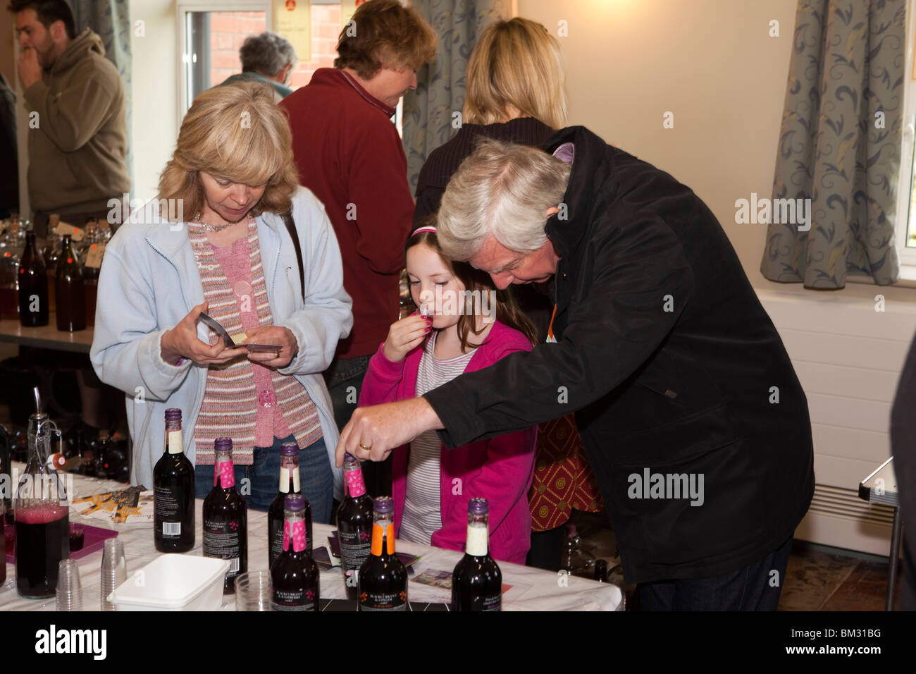 UK, England, Herefordshire, Putley, Big Apple Event, young visitor sampling fruit juice Stock Photo