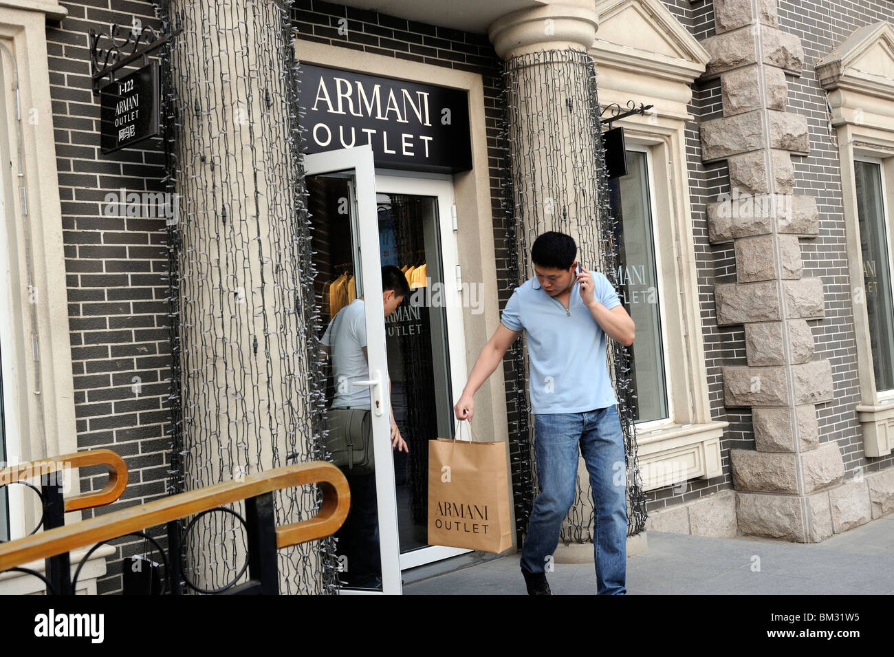 Two Chinese me leave ARMANI outlet store at Beijing Scitech Premium Outlet  Mall in Beijing, China. 15-May-2010 Stock Photo - Alamy