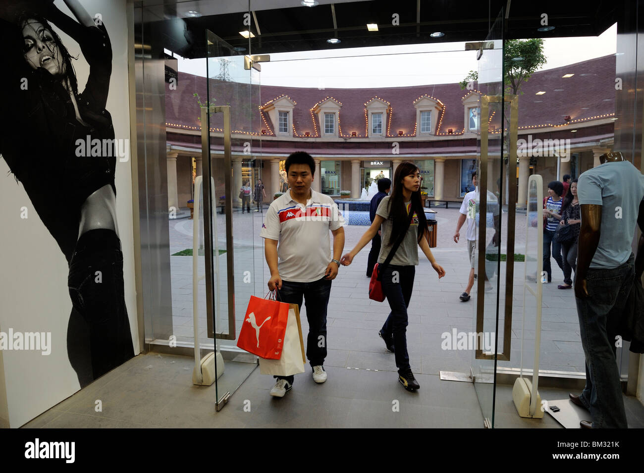 Chinese couple step into a Calvin Klein Jeans store after at Beijing  Scitech Premium Outlet Mall in Beijing, China. 15-May-2010 Stock Photo -  Alamy